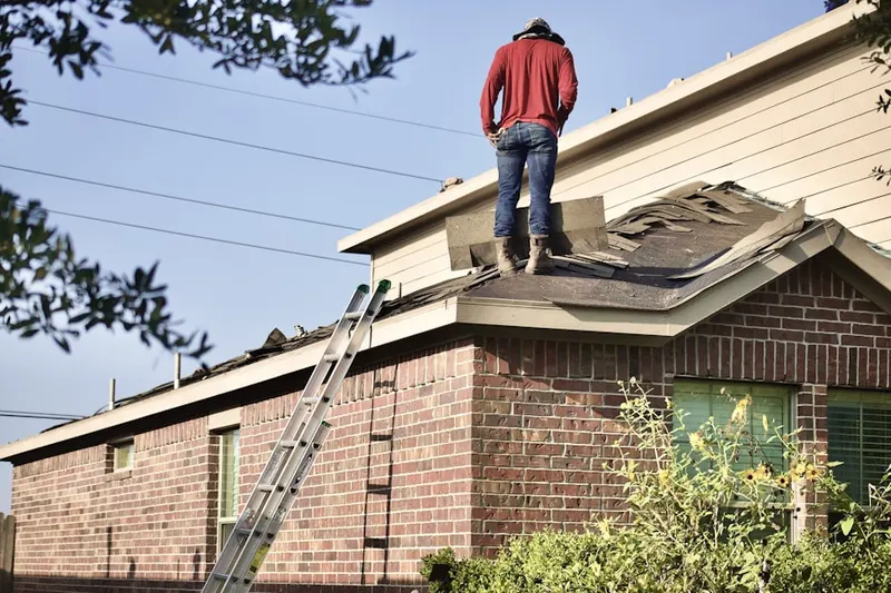 Professional roofer working on a residential roof in Great Oak Farms
